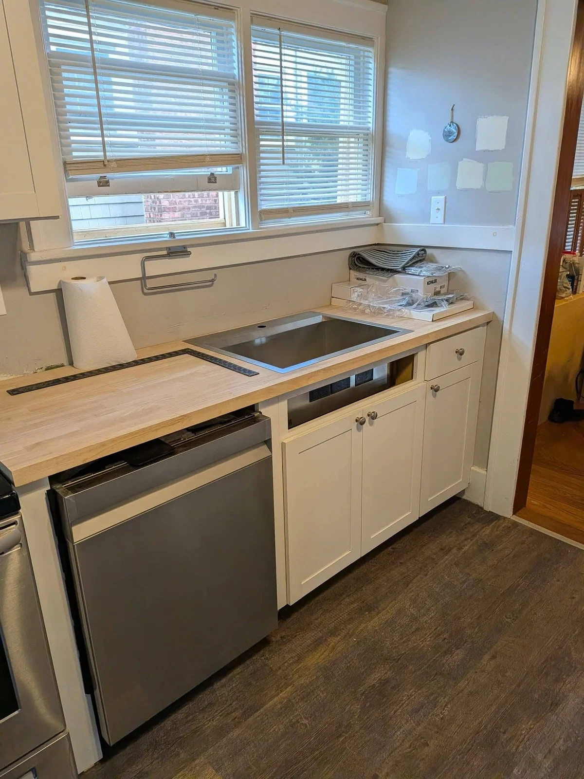 Kitchen cabinets and wood countertop with installation supplies visible